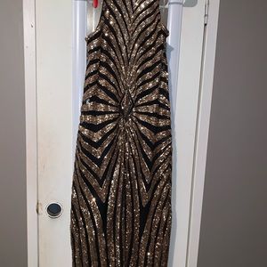 A black and gold sequins dress